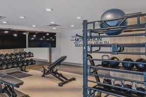 A gym with weightlifting equipment, dumbbells, and exercise balls. - The Oak Haven | 2BR+2BA | Central | Pool&Sauna (Kelowna)