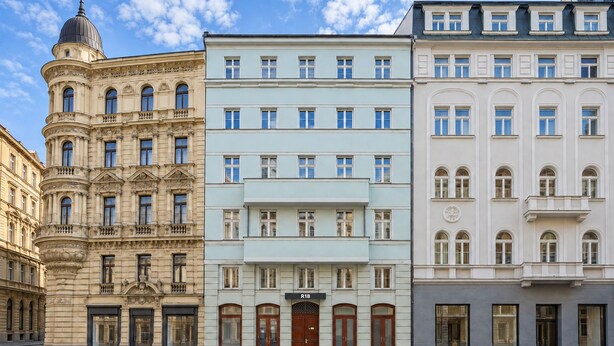 A row of multi-story buildings with classical architecture, featuring ornate facades and large windows. - R18 Residences Prague (Hlavní město Praha)