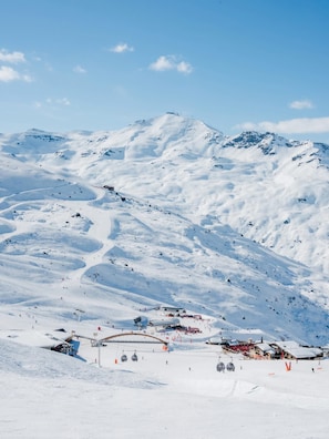 A snow-covered mountain with ski slopes and a ski lift. - "V24" by Versant Collection (Les Belleville)