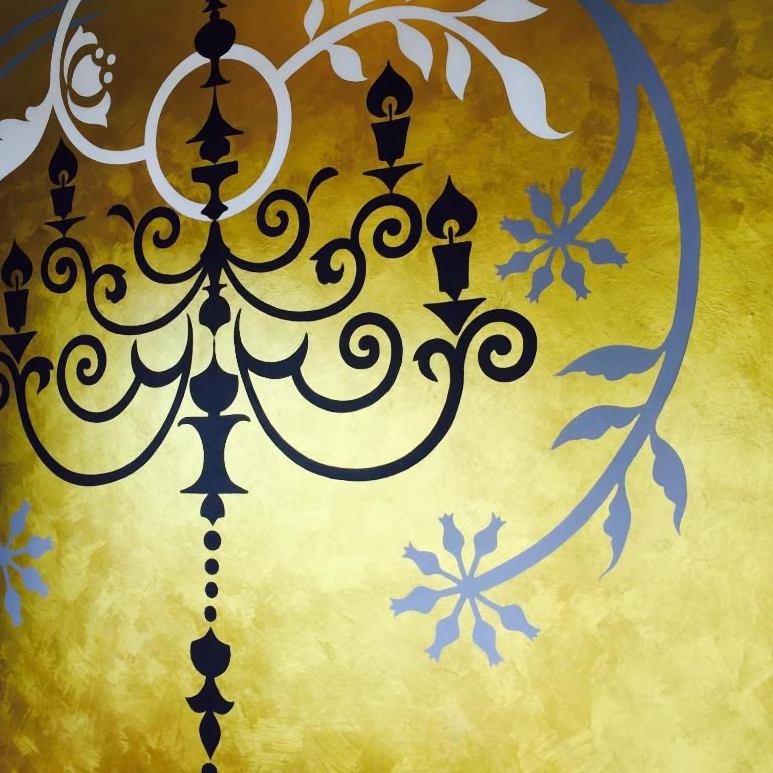 A decorative wall with a central black chandelier design and floral patterns.