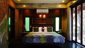 A hotel room with a bed, a headboard, an air conditioning unit, and a view through the window. - soi one boutique bedrooms (pai)