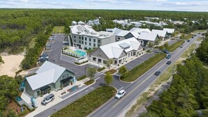 A commercial area with multiple buildings, a parking lot, and a road. - Seagrove Groove D102-Beach Access-Sleeps 8 (Seagrove Beach)