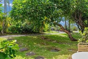 A garden with a curved pathway, a bench, and a table. - Napili Shores #d-128 1 Bedroom Condo (Lahaina)