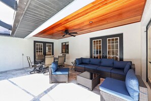 An outdoor patio with a ceiling fan, a sofa, and a dining table. - Lakeland 4br Vacation Home Sleeps 9 Pool 4 Bedroom Home (Lakeland)