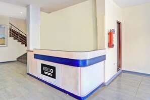A hotel reception desk with a sign indicating it is company-serviced. - Hotel O Rane Nagar (Nashik)