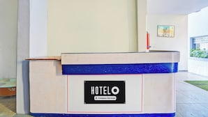 A hotel reception desk with a sign indicating it is company-serviced. - Hotel O Rane Nagar (Nashik)