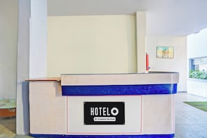A hotel reception desk with a sign indicating it is company-serviced. - Hotel O Rane Nagar (Nashik)