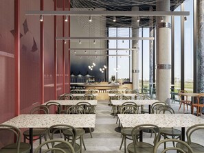 A modern restaurant interior with multiple tables and chairs, a bar area, and large windows offering views.