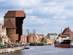 A historic building with a prominent tower and a waterfront view.