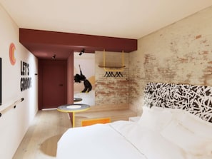 A modern bedroom with a bed, a small table, and a wall with a graffiti-style design. - Ibis Styles Valence (ouverture Automne 2026) (Valence)