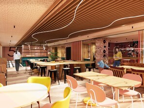 A modern interior with wooden tables and chairs, a brick wall, and a number '5' sign. - Ibis Styles Valence (ouverture Automne 2026) (Valence)