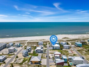 A coastal residential area with houses, a beach, and a clear sky. - New Listing! 2 Relax N is a luxury home offering gulf views, 2 master suites, 3 (Mexico Beach)