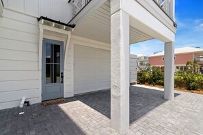 A residential building with a covered porch, a door, and a brick pathway. - New Listing! 2 Relax N is a luxury home offering gulf views, 2 master suites, 3 (Mexico Beach)