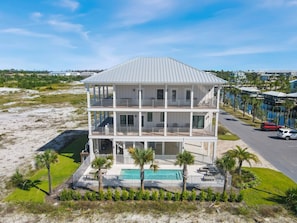 A multi-story beachfront property with a pool, balconies, and a view of the ocean. - NEW HOME! AMISTAD IS AN UPSCALE 6BD/4BA HOME W/GULF & CANAL VIEWS, PRIVATE POOL! (Mexico Beach)