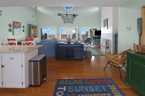 A spacious living area with a kitchen, dining area, and a view of the outdoors. - CABANA DEL SOL IS A 2BD/2BA GULF FRONT W/AMAZING VIEWS, 2 SCREEN PORCHES! (Port Saint Joe)