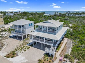 A coastal property with two-story buildings featuring balconies and a view of the ocean. - Carpe Diem,  A Luxury Home With Amazing Gulf Views Views, Fire Pit, Pet-Friendly (Port Saint Joe)