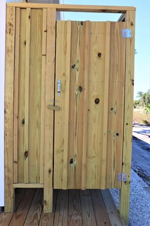 A wooden partition with a latch and a metal bracket. - THIS DUPLEX IS PERFECT FOR LARGE FAMILIES/ MULIIPLE FAMILES! STEPS AWAY FROM THE (Mexico Beach)