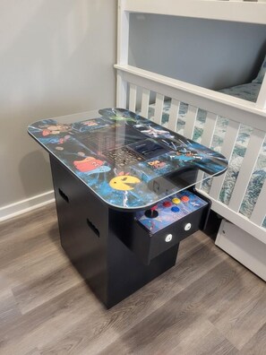 A small, black, child-friendly table with a colorful, cartoon-themed tabletop and a few buttons on the side. - THE "CRABBY HUNTER" IS A NEW HOME W/GULF VIEWS, PRIVATE POOL & OPTION TO RENT GO (Mexico Beach)