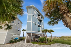 A multi-story beachfront property with a paved driveway, palm trees, and a view of the ocean. - Oak Rest Barn, is a custom built gulf front home w/pool, pet friendly, $250 cred (Port Saint Joe)