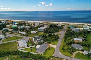 A coastal residential area with houses, roads, and a beach. - SERENITY ON SEA STREET IS 650 FT TO BEACH! SCREENED PORCH, FENCED-IN YARD! (Mexico Beach)