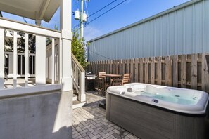 A backyard with a hot tub, wooden deck, and a barbecue grill. - NEW LISTING! Special Sunset is steps to beach, hot tub, fenced backyard and pet (Mexico Beach)