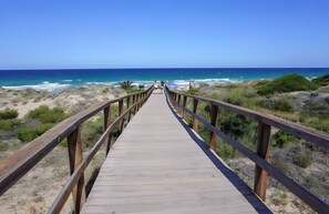 Una pasarela de madera que conduce a una playa con vistas al océano.