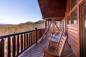 A wooden deck with a railing overlooking a natural landscape. - Stylish 8BR Cabin - Hot tub & Views - Sevierville (Sevierville)