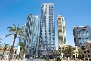 A high-rise building with a modern design, featuring multiple floors and a prominent glass facade. - Kensington Iconic Burj View Dubai Mall (Dubai)