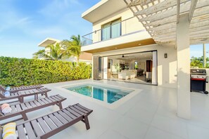 A modern two-story house with a swimming pool, outdoor seating, and a barbecue area. - 25% Off Oct 7-15, Private Pool, Walk 2 Beach/Shops (Grace Bay)