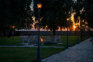 A park pathway with benches and street lamps. - Chateau Davitiani (Kvareli)