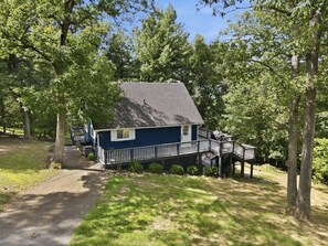 A house with a deck and a covered porch, surrounded by trees. - A-Frame Soak and Cedar near Skyline Drive and Wineries (Front Royal)