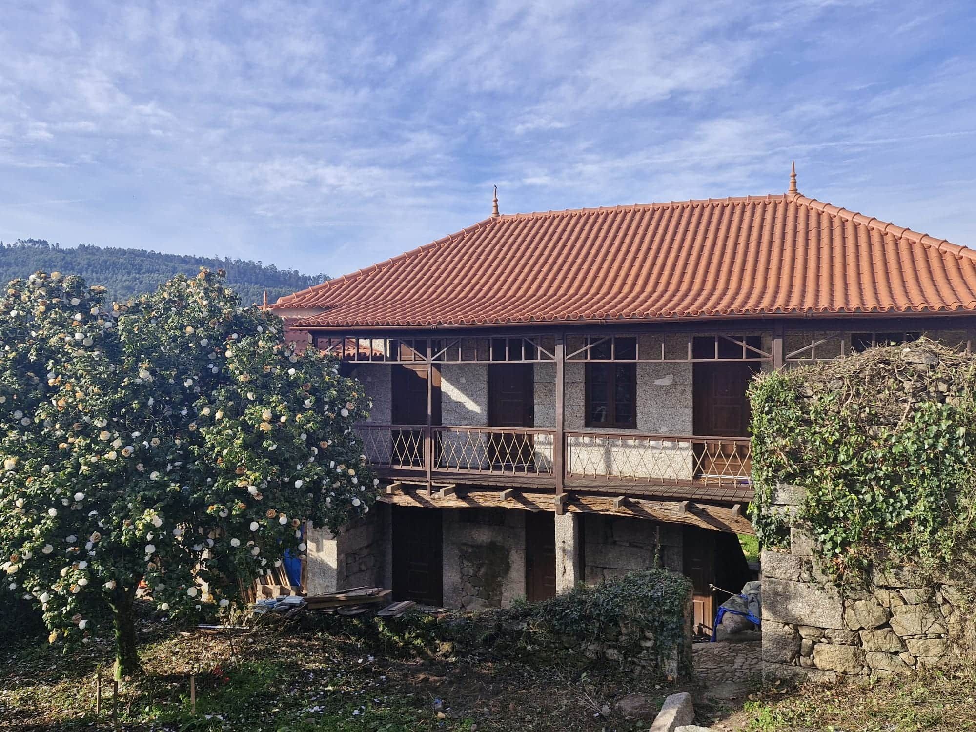 A traditional building with a tiled roof and a balcony.