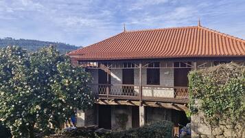 A traditional building with a tiled roof and a balcony.