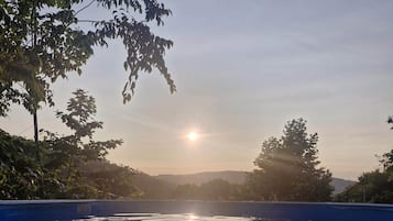 A clear view of a swimming pool with calm water reflecting the sky.