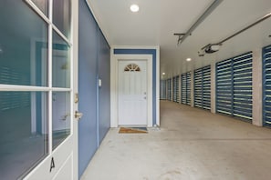 A hallway with a white door, blue walls, and a row of blue lockers on the right. - Murrells inlet Peeps (Murrells Inlet)
