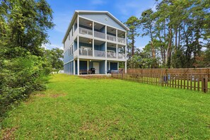 A two-story building with a balcony on the upper floor, surrounded by a wooden fence and greenery. - Murrells inlet Peeps (Murrells Inlet)