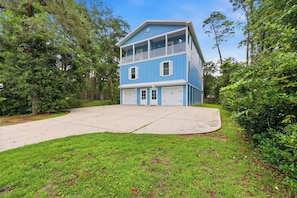 A two-story house with a front porch, garage, and a driveway. - Murrells inlet Peeps (Murrells Inlet)