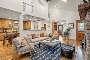 A spacious living area with a sofa, coffee table, and a fireplace. - Abode on Norfolk, Old Town PC home, hot tub, walk to Town Lift (Park City)