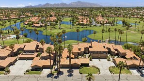 Zona residencial com várias casas, campo de golfe e um grande corpo de água.