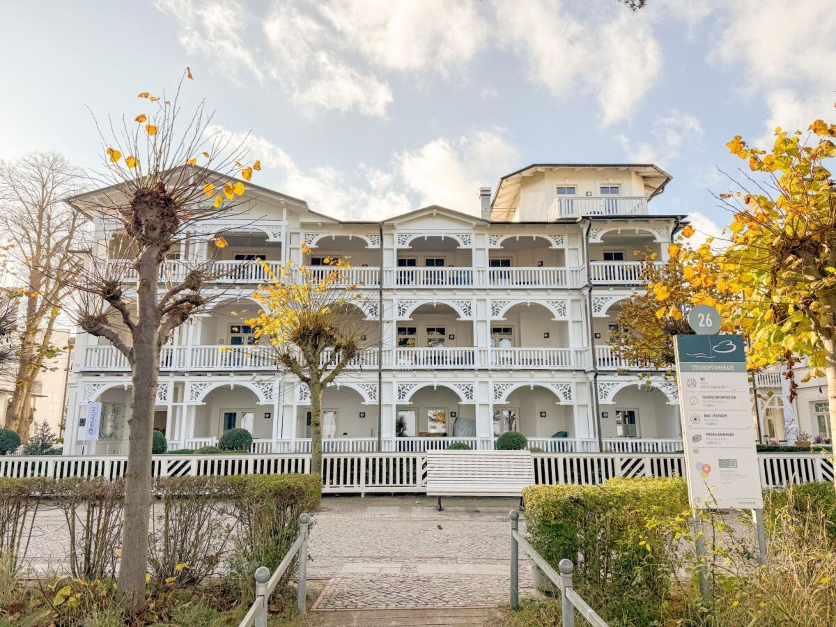 A multi-story hotel with balconies and a central courtyard.