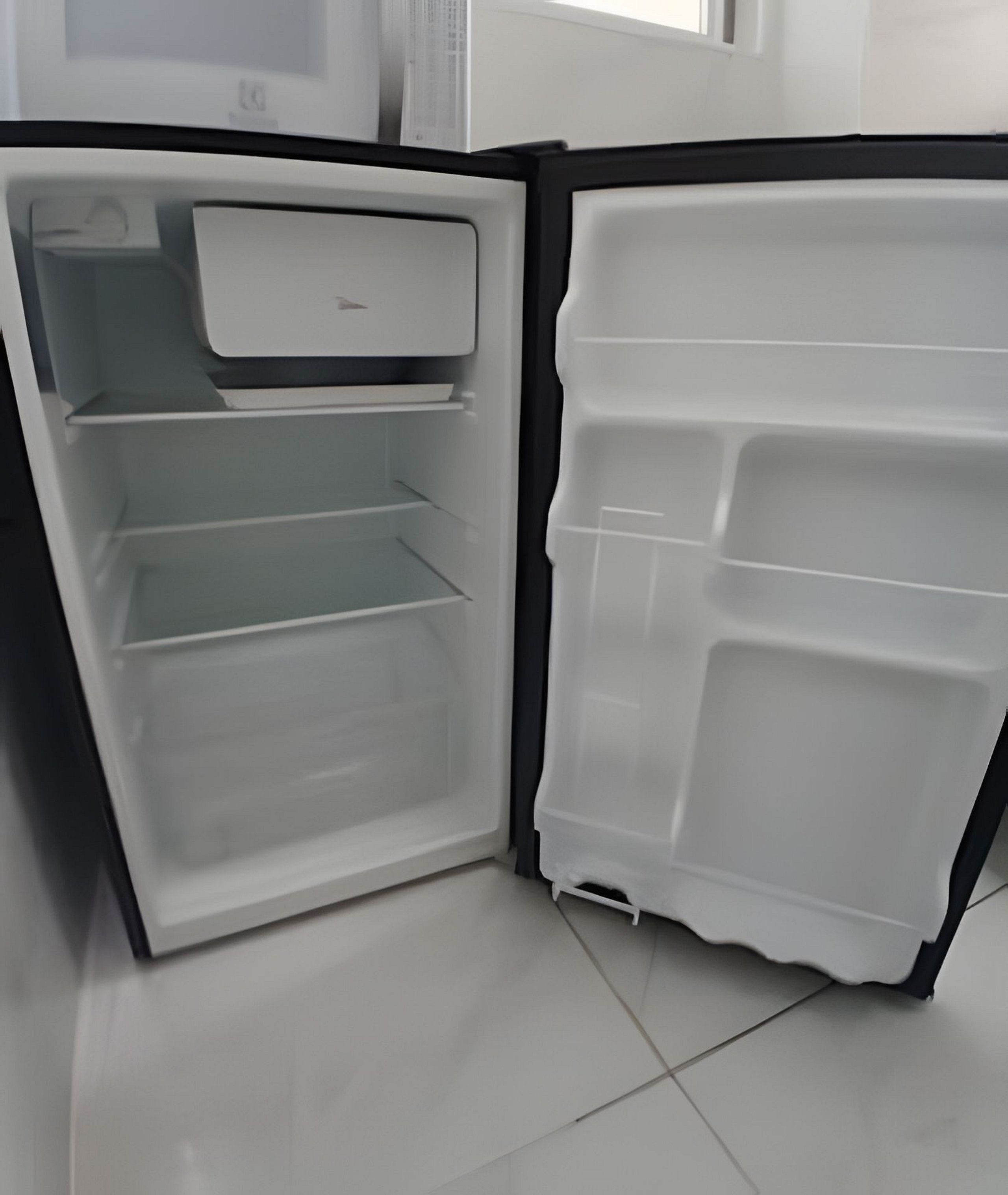 An open refrigerator with multiple shelves and compartments.