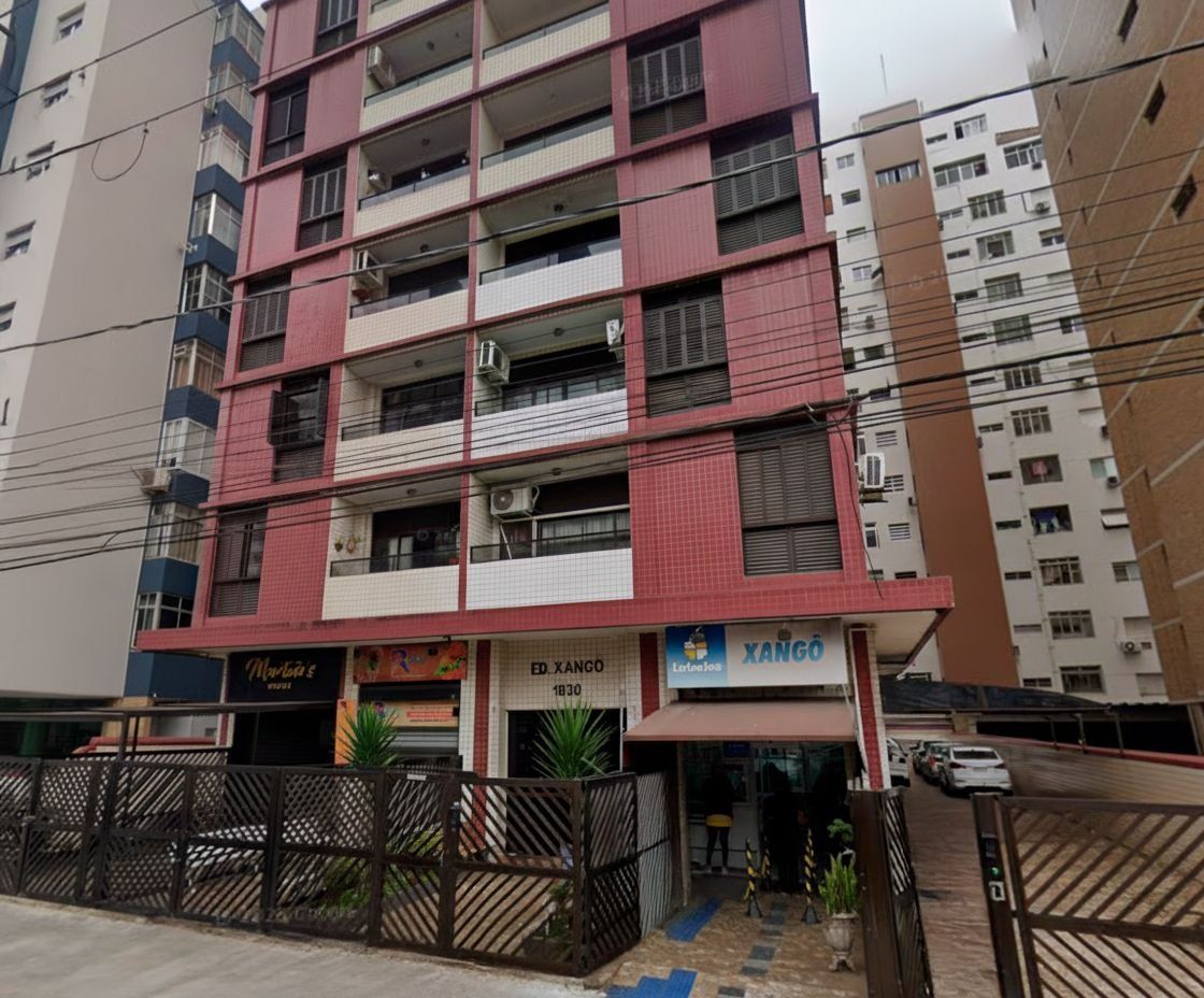 A multi-story building with balconies, a storefront named 'ED. XANGO', and a sign for 'XANGO'.