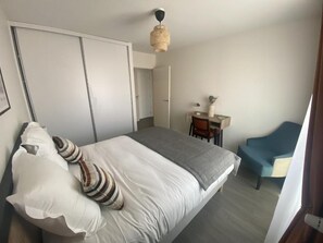 Ein Schlafzimmer mit einem Bett, einem Schreibtisch und einem Stuhl.
