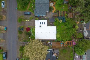 An aerial view of a residential area with a large white building, a road, and surrounding greenery. - Cozy 3BR Broadview Retreat | Near Transit & Parks (Seattle)