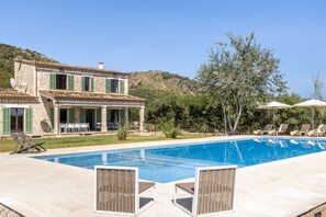 A two-story stone house with a swimming pool, outdoor seating, and a hillside backdrop. - Son Barba Mallorca – Private Villa (Sa Pobla)