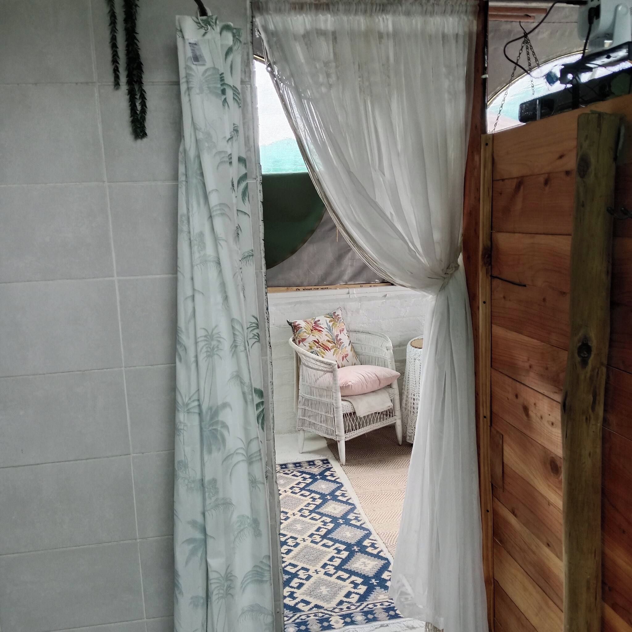 A room with a bed, a chair, and a patterned rug.