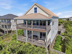A multi-story residential building with a balcony, a garage, and a driveway. - Shining Sea at North Topsail Beach, Steps to the Beach, Dog Friendly (North Topsail Beach)