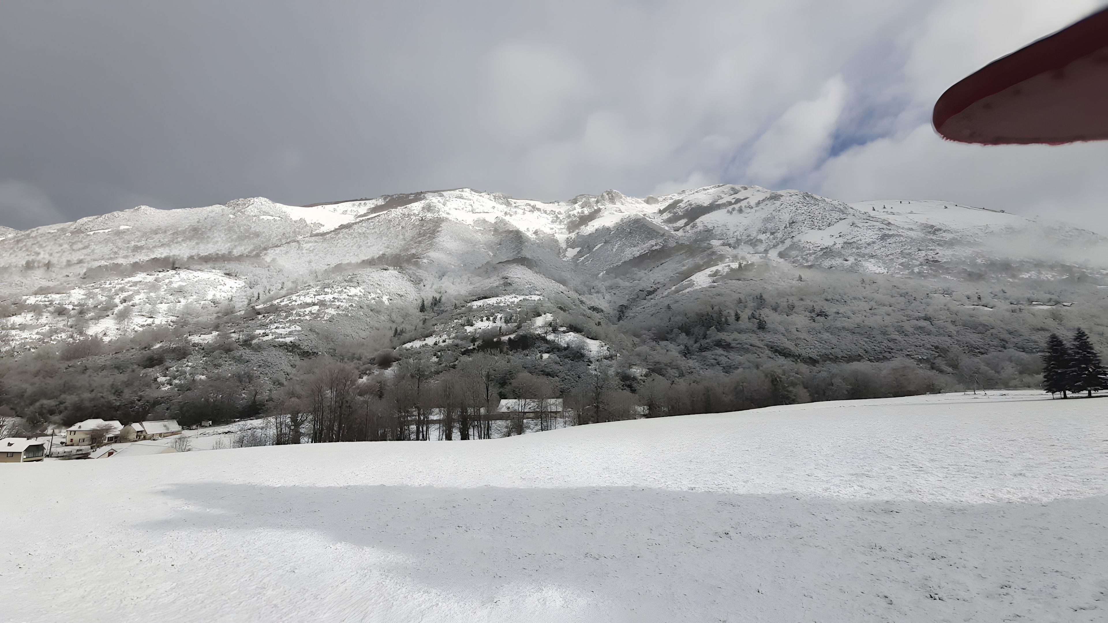 A snow-covered mountain landscape with a clear sky.