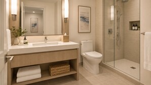 A modern bathroom with a glass-enclosed shower, a white sink, and a toilet. - Downtown Top Suites - S Avenue  (Toronto)