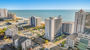 A coastal cityscape with high-rise buildings, a beach, and a clear sky. - Bluewater Resort 920-Oceanfront I/O Pool-Hot tub (Myrtle Beach)